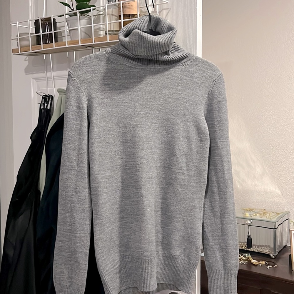 Gray, snug fitting turtleneck.